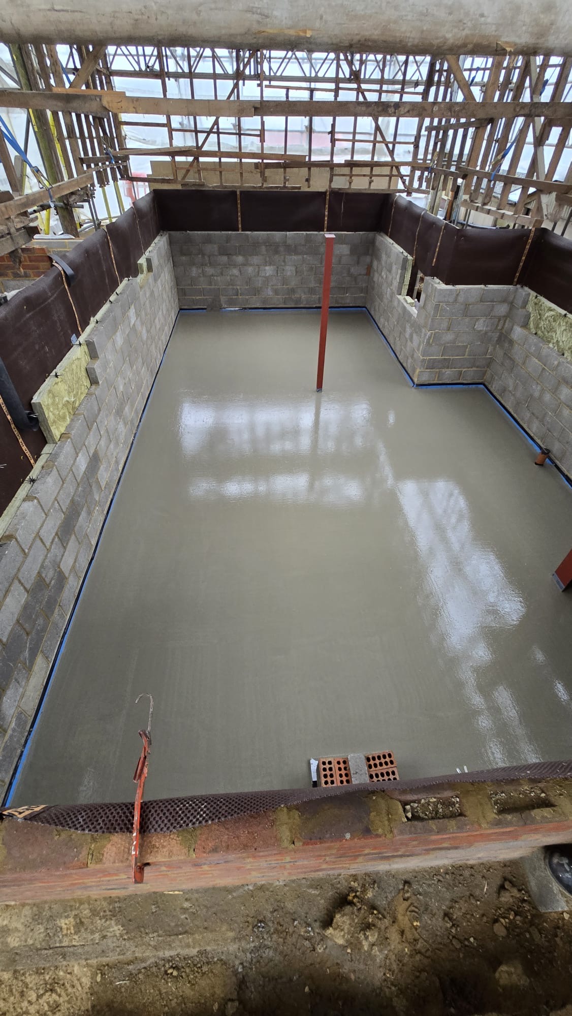 Liquid screed floor completed on a scaffolded new build extension