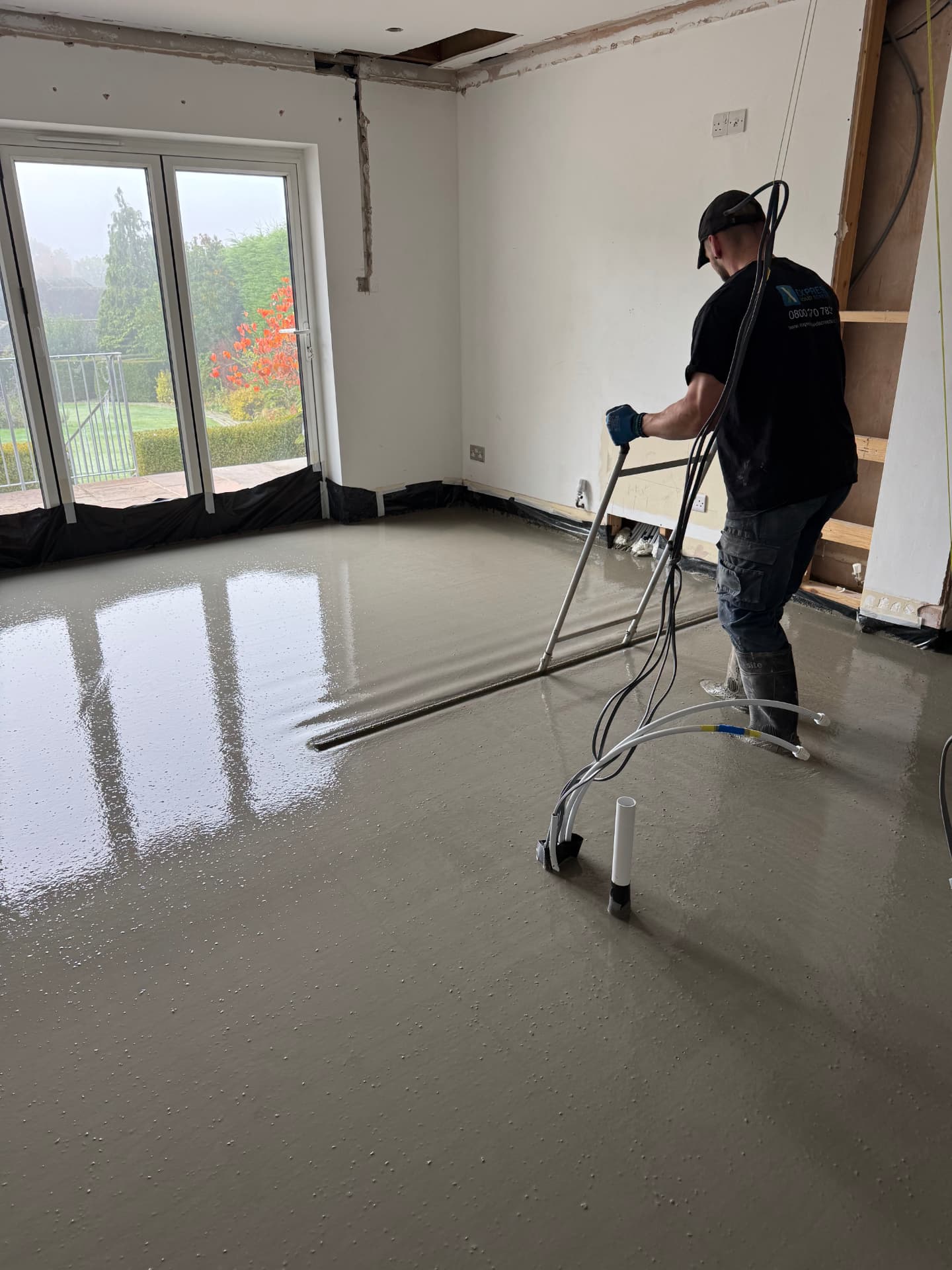 Our installer pumping liquid screed in a home renovation